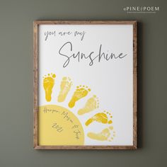 a sign that says you are my sunshine and two yellow footprints on the bottom of it