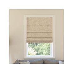 a living room with a couch and window covered in roman blind shades on the windowsill