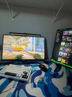 two computer monitors sitting next to each other on top of a desk with a keyboard and mouse