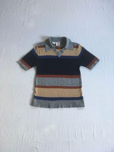 vintage 1970s knit shirt sweater  Alfie California synthetic knit striped short sleeve v neck collared grey, blue, brown, black good vintage condition, light wear- light pilling-see photos no label size fits most like S/M-see below measures, lying flat, shoulder-15 1/2" chest-16" and stretches to 19" sleeve-9" length-23 1/2" Retro V-neck Relaxed Fit Top, Fitted Top With Striped Johnny Collar, Fitted Top With Johnny Collar And Striped Detail, Striped Short Sleeve Tops For Fall, Retro Striped V-neck Top, Fitted Striped Collared T-shirt, Striped Short Sleeve T-shirt For Fall, Striped Short Sleeve Fall T-shirt, Fall Striped Short Sleeve T-shirt