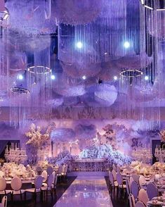 an elaborately decorated ballroom with chandeliers and tables