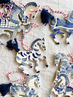 several handmade wooden horses are displayed on a tablecloth with red, white and blue streamers