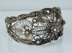 "A spectacular cuff. This Chinese Export cuff is crafted from 900/1000 silver and features an intricate spun wire filigree design. The cuff is in very good condition and is not missing any of the filigree, there it does have a noticeable ding. It is clearly hallmarked \"CHINA SILVER\", weighs 46.1 grams, and test positive for a minimum of 900 silver. The cuff measures approximately 6 inches end to end with a 1 1/2 inch opening and is 1 5/8 inches at the widest point. A fantastic example of Chine Victorian Cuff Bracelet With Intricate Design, Ornate Adjustable Cuff Bracelet With Intricate Design, Adjustable Ornate Cuff Bracelet With Intricate Design, Antique Silver Cuff Bracelet With Intricate Design For Wedding, Victorian Filigree Bangle Cuff Bracelet, Antique Silver Wedding Cuff Bracelet With Intricate Design, Ornate Cuff Bracelet With Intricate Design For Wedding, Ornate Cuff Bracelet For Wedding With Intricate Design, Wedding Antique Silver Cuff Bracelet With Intricate Design