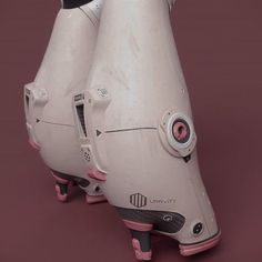 two white and pink futuristic looking objects on wheels