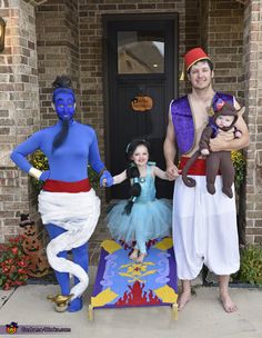 three people in costumes are standing on the front porch with their hands in each other's pockets