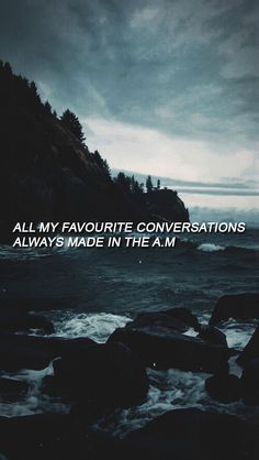 an ocean with rocks and the words all my favorite conversations are always made in the am