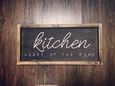 a wooden sign that says kitchen heart of the home