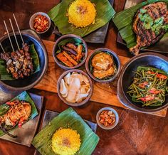 a table topped with lots of different types of food on top of wooden trays