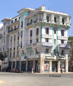 an old building with balconies on the top and second story is painted in pastel colors