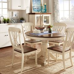 a dining room table with four chairs around it