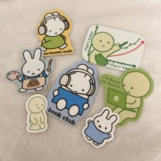 some stickers are laying on a white surface and one has a rabbit in the car