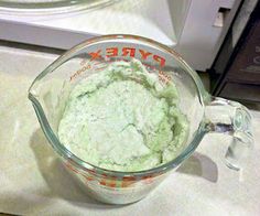 a blender filled with green liquid on top of a counter