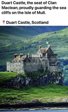 an old castle sitting on top of a lush green hillside next to the ocean and mountains