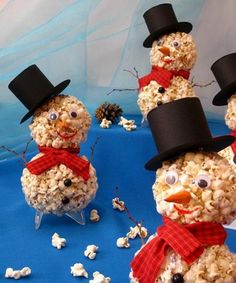 three snowmen made out of popcorn and wearing hats