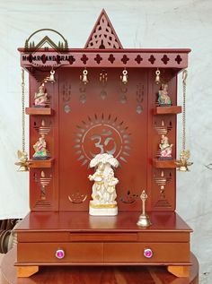 a wooden shrine with various items on it's shelf and decorations around the top