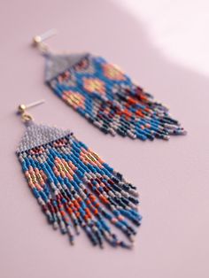 Drawing inspiration from Guatemala's intricate woven Huipil textiles, these handwoven statement fringe earrings merge highly reflective beads at the top with an array of vibrant cascading fringe. The fringe creates geometric and floral motifs, paying homage to the symbolic designs found in traditional Huipiles. Add som Studio Weave, Steel Post, Handmade Beaded Jewelry, Beautiful Inside And Out, The Fringe, Fringe Earrings, Floral Motifs, Handmade Artisan, Bead Weaving