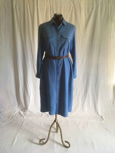 "vintage 1970s shirt dress LL Bean pure silk, slight nubby w/white undertones to weave button up long sleeve smoky blue collared w/point stays breast pocket w/button flaps side pockets about mid calf length, depending on wearer's height good vintage condition, light wear-see photos, light fade,slub, nothing major belt not included labeled size 14, see below measures, lying flat, shoulder-16\" chest-21\" waist-20 1/2\" hip-22\" sleeve-22 1/2\" length from top shoulder-46\"" Spring Long Shirt Dress With Pockets, Long Shirt Dress With Pockets For Spring, Long Shirt Dress With Button Closure For Spring, Classic Fall Shirt Dress With Pockets, Classic Fall Button-up Shirt Dress, Fitted Long Sleeve Shirt Dress With Pockets, Fitted Shirt Dress With Pockets For Fall, Long Shirt Dress For Spring Workwear, Collared Single Breasted Shirt Dress For Spring