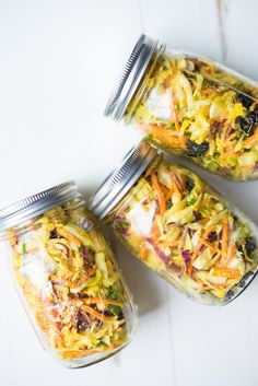 three mason jars filled with food sitting on top of a white counter next to each other