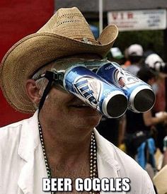 a man wearing a cowboy hat and sunglasses with beer cans on his face as he looks into the distance