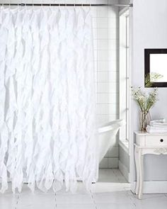 a white bath tub sitting next to a shower curtain