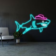 a neon shark with a hat on it's head is in front of a wall