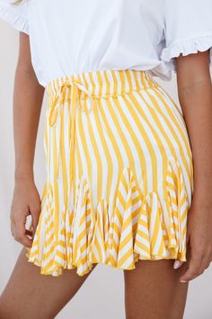 Twirl the day away in this adorable skirt featuring an elasticated waist with drawstring, prettiest stripe print fabric and flounce-frill inserts around the hem. Perfect for your Spring/Summer wardrobe. Pair it with a cool white tee or tank top. Dress it up with some tan wedges or go casual with some crisp white sneakers for a look we are loving. Tulle Mini Skirt, Ruffle Skirts, Striped Mini Skirt, Short Pollera, Chic Summer Style, North Beach, Layered Skirt, Summer Skirts, Stripe Skirt