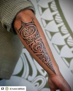 a man's arm with an intricate tattoo design on the left side of his arm