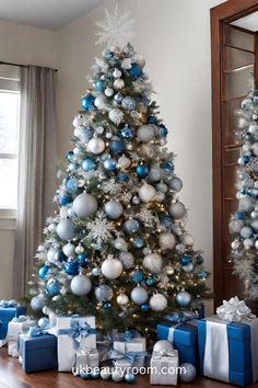 a decorated christmas tree with blue and silver ornaments