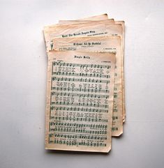 three old sheet music sheets are stacked on top of each other