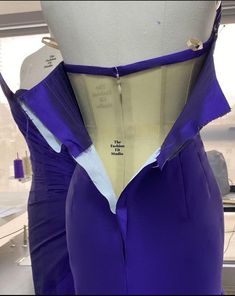 the back of a purple dress on display