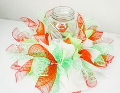 a jar filled with lots of different colored ribbons