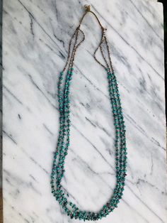 3 Strands of Genuine Heishi and Turquoise Necklace done on traditional threading and no clasp needed. Material: 3 mm, New Mexico turquoise nugget, tiny Heishi (shell beads). Length: 32 inches. Layer with a combo of other necklaces for a hobo chic vibes. (shown in photo) Hobo Chic, Heishi Necklace, Tahitian Pearl Necklace, Nugget Necklace, Chic Vibes, Necklace Ideas, Jewelry Cabinet, Rose Quartz Necklace, Necklace Brands