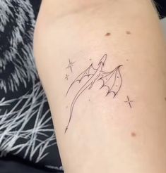 a woman's arm with a small tattoo on the left side of her leg