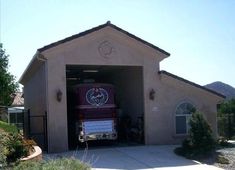 a fire truck is parked in the garage with its door open to let people know what's inside