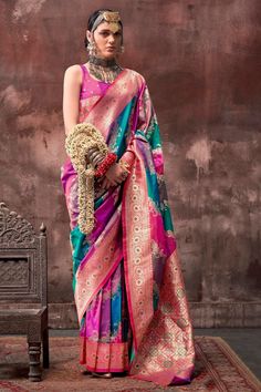 This Handloom Banarasi Saree is a masterpiece of traditional craftsmanship, featuring a vibrant rangkaat hue that exudes elegance. Its intricate handwoven patterns, combined with luxurious zari work, create a stunning visual appeal. The soft, flowing fabric drapes beautifully, making it an ideal choice for special occasions.  --------------------------------- S A R E E ● D E T A I L S --------------------------------- ● Fall and Edging : Done ● Tassel : See in Option ● Petticoat : On request Extra Charges ● Drapping Saree (Ready to wear) : On Request Extra Charges ● Blouse : Matching Unstitched Piece (See in option) ● Occasion : Wedding, Party, Festive, Function ● Type: Bollywood ● Includes : 1 Saree, 1 Blouse Piece ● Saree length : 5.5 meter ● Blouse piece : 0.8 meter ● Wash Instruction:- Rangkat Saree, Multi Color Saree, Art Silk Sarees, Zari Work, Banarasi Saree, Organza Saree, Banarasi Sarees, Draped Fabric, Pink Silk