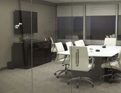 an empty conference room with glass walls and white chairs