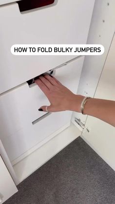 a person is opening the bottom drawer of a white cabinet with text over it that reads how to fold bulk jumpers