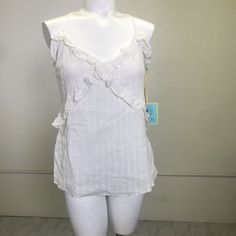 Approx Measurements: Bust Across: 20" Length: 19" Details: V-Neck, Adjustable Straps, Ruffle Trim, Metallic Threading Material: Cotton, Metallic Lining Condition: Nwt M- 0249 White V-neck Top With Ruffles, Fitted V-neck Camisole With Ruffles, Chic Cotton Camisole With Ruffled Straps, Cotton Camisole With Ruffled Straps For Summer, Summer Cotton Camisole With Ruffled Straps, White Cotton Tops With Ruffled Straps, Cotton Ruffled Camisole For Day Out, Cotton Ruffle Camisole For Day Out, Fitted V-neck Tank Top With Ruffles