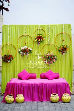 a bed sitting under a green screen with flowers on it