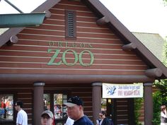 people are standing in front of a building with a sign that says oregon zoo on it