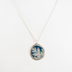 A Cyanotype photograph of a leaf are encased in a sterling silver frame and jeweler's resin, with sterling silver ear hooks. Jen's jewelry is limited edition and one-of-a-kind art jewelry made with her own or collected photography, fine metals, and resin. Says Jen, "I created my first collection of Photo-Jewelry nearly 20 years ago. This idea came to me as a direct result of my art school education at Pratt Institute, where I majored in photography and my work experience as a studio assistant. M Silver Nature-inspired Jewelry, Etched Sterling Silver Jewelry As Gift, Sterling Silver Etched Jewelry For Gifts, Silver Square Pendant Jewelry, Sterling Silver Etched Jewelry As Gift, Silver Square Pendant Jewelry With Soldered Details, Silver Jewelry With Soldered Square Pendant, Etched Nature-inspired Silver Jewelry, Etched Silver Nature-inspired Jewelry