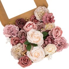 a bunch of flowers that are sitting in a cardboard box on a white background,