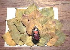 a close up of a plate with leaves and a turkey head on top of it