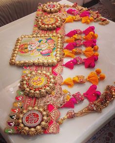 a table topped with lots of assorted necklaces and bracelets on top of it