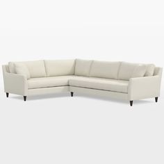 a white sectional couch sitting on top of a white floor