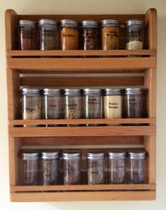 wooden spice rack filled with lots of different types of spices