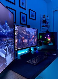 two computer monitors sitting next to each other on top of a desk in front of pictures