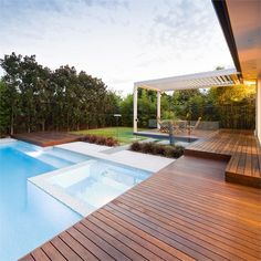 a wooden deck next to a swimming pool