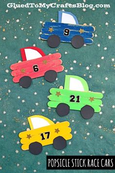 three popsicle stick race cars with numbers on them and stars in the back ground