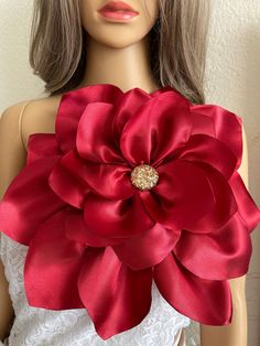 a mannequin with a red flower on it